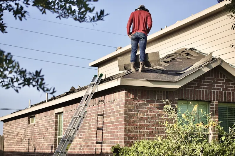 Professional roofer working on a residential roof in Clover Leaf Farm